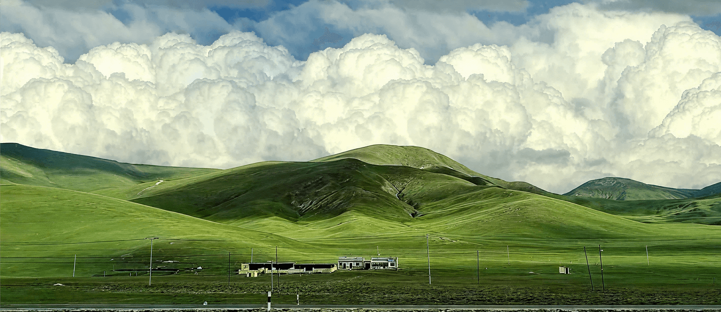 Green hills under a cloudy sky
